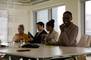 Smiling businesswoman in conference room meeting