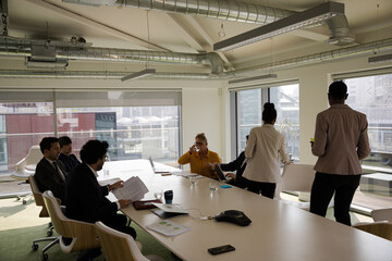 Business people leaving conference room after meeting