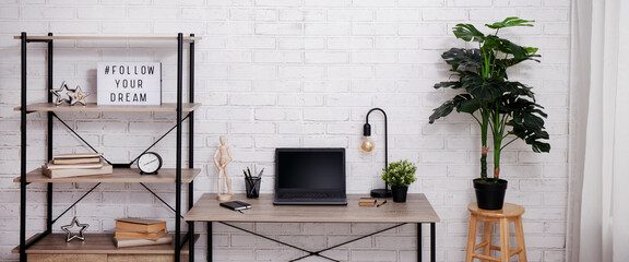 Fototapeta na wymiar Modern workspace with laptop in bright office