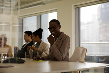 Smiling businesswoman in conference room meeting