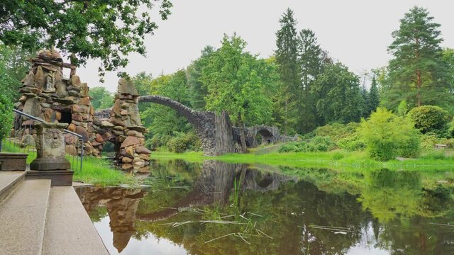 Rakotz Bridge, Rakotzbrucke in Kromlau, Saxony, Germany. Fantastic landscape in Azalea and Rhododendron Park Kromlau. Reflection of bridge in water of Rakotzsee. traveling and travel goals for tourism