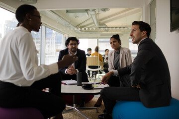 Business people discussing paperwork in relax zone