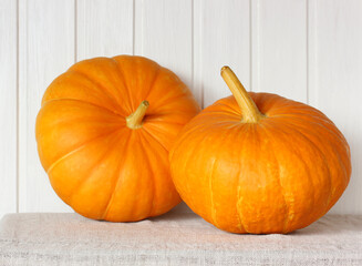 two orange pumpkins on the table