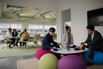 Business people discussing paperwork in relax zone