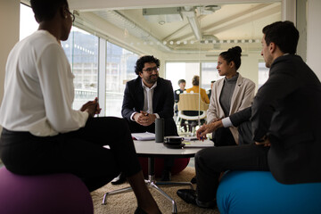 Fototapeta premium Business people discussing paperwork in relax zone