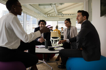 Business people discussing paperwork in relax zone