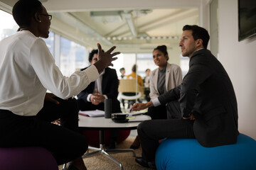 Business people discussing paperwork in relax zone