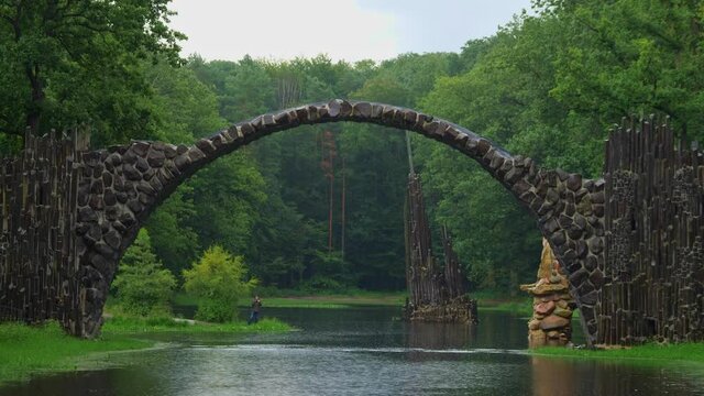 Rakotz Bridge, Rakotzbrucke in Kromlau, Saxony, Germany. Fantastic landscape in Azalea and Rhododendron Park Kromlau. Reflection of bridge in water of Rakotzsee. traveling and travel goals for tourism