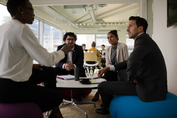 Business people discussing paperwork in relax zone