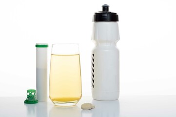 Sports plastic flask and vitamins. Soluble vitamins and minerals. Isotonic in a glass.
