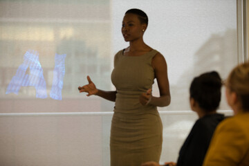 Portrait of confident businesswoman leading conference room meeting