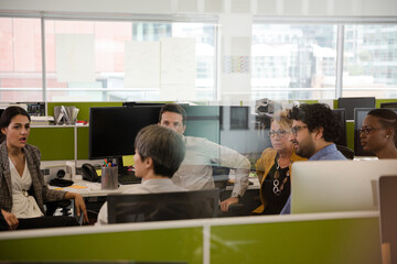 Businessmen talking in open plan office