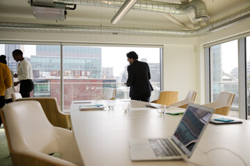 Business people leaving conference room after meeting