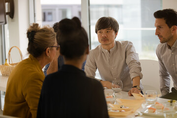 Business people eating sushi lunch in conference room