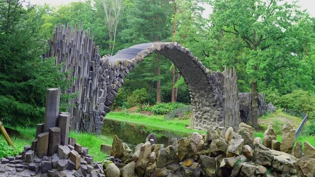 Rakotz Bridge, Rakotzbrucke in Kromlau, Saxony, Germany. Fantastic landscape in Azalea and Rhododendron Park Kromlau. Reflection of bridge in water of Rakotzsee. traveling and travel goals for tourism