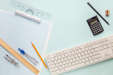 The student engineer's accessories - compass,  drawing,  pencil on  blue background. Top View. International Students' Day
