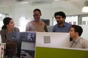 Business people brainstorming in open plan office