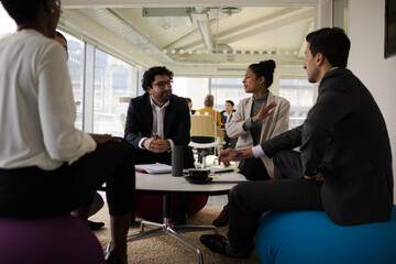 Fototapeta premium Business people discussing paperwork in relax zone