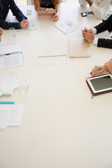 Paperwork and electronics on conference room table