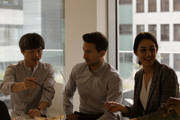 Business people eating sushi lunch in conference room