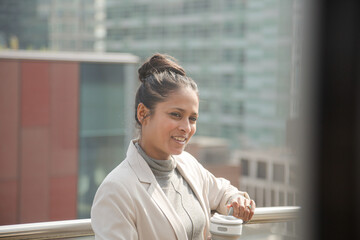 Portrait of businesswoman enjoying view from balcony