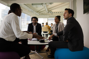 Business people discussing paperwork in relax zone