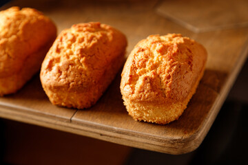 close up vanilla baked cupcakes with currants on a wooden table