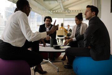Business people discussing paperwork in relax zone