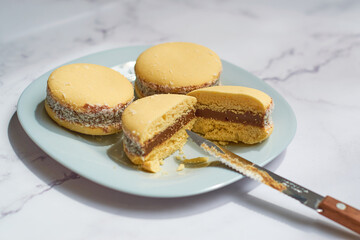 Traditional Argentinian alfajores with dulce de leche on marble table. Argentine gastronomy concept.