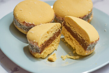 Traditional Argentinian alfajores with dulce de leche on marble table. Argentine gastronomy concept.