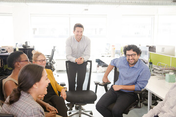 Business people meeting at computer in open plan office