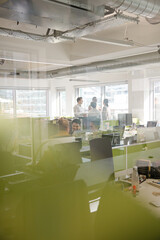 Business people talking in open plan office