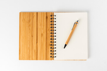 notebook with bamboo cover and white sheets with matching pen