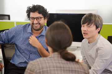 Business people talking in open plan office