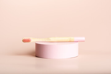Two eco friendly pink and blue natural bamboo toothbrushes on pink background. Health care, copy space. Zero waste concept.