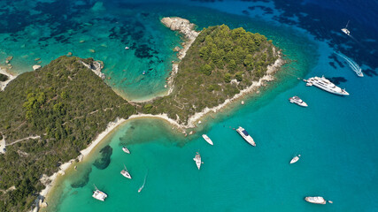 Obraz premium Aerial drone photo of luxury yachts and sail boats anchored in tropical exotic island emerald bay with crystal clear calm sea
