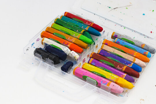 Old used colored crayons for drawing isolated on a white background. Concept of Creativity, young artist, and back to school.