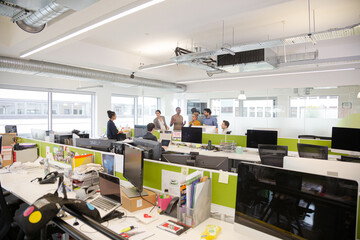 Business people talking in open plan office
