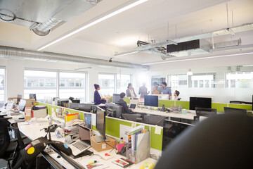 Business people talking in open plan office