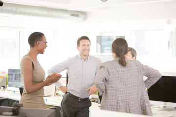 Fototapeta na wymiar Business people talking in open plan office