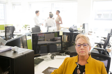 Portrait of businesswoman in open plan office