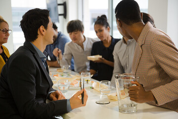 Happy business people enjoying sushi lunch
