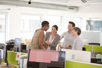 Business people talking in open plan office