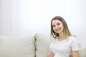 Cropped view of cute pregnant woman on white background.