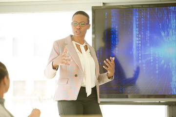 Businesswoman leading conference room meeting