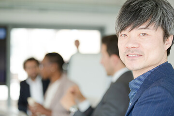 Portrait of businessman in conference room meeting