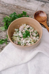 Summer salad with herbs and wooden spoon. Okroshka. Natural