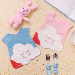 Pink and blue bibs for children. Protecting children from dirt while eating
