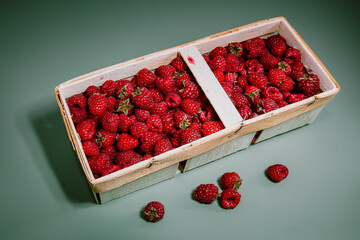 Ripe raspberries on an organic green background