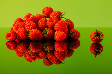 Ripe raspberries on an organic green background